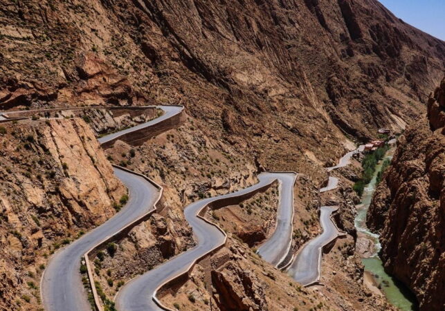 a winding road in a rocky mountain