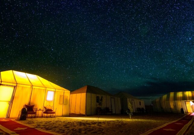 a group of tents lit up at night