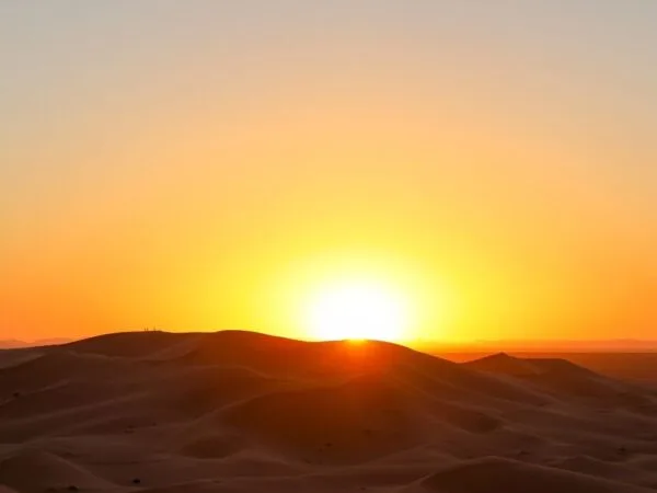 a sunset over a desert