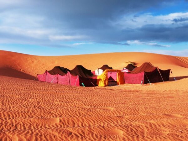 tents in a desert with sand dunes
