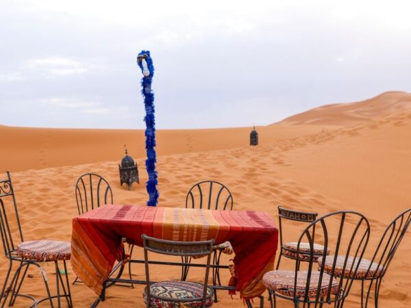 a table and chairs in a desert