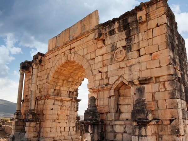 a stone arch with columns