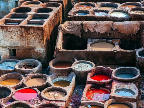 a group of containers with different colors of paint
