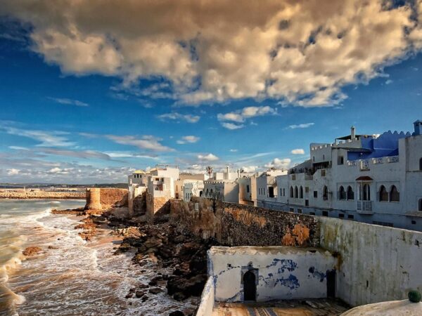 a white buildings on a rocky beach