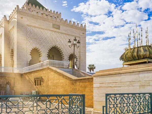 a building with a fence and a blue sky