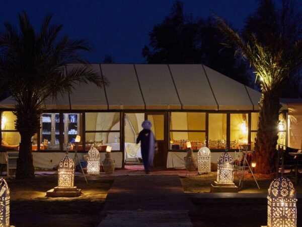 a building with lanterns and palm trees