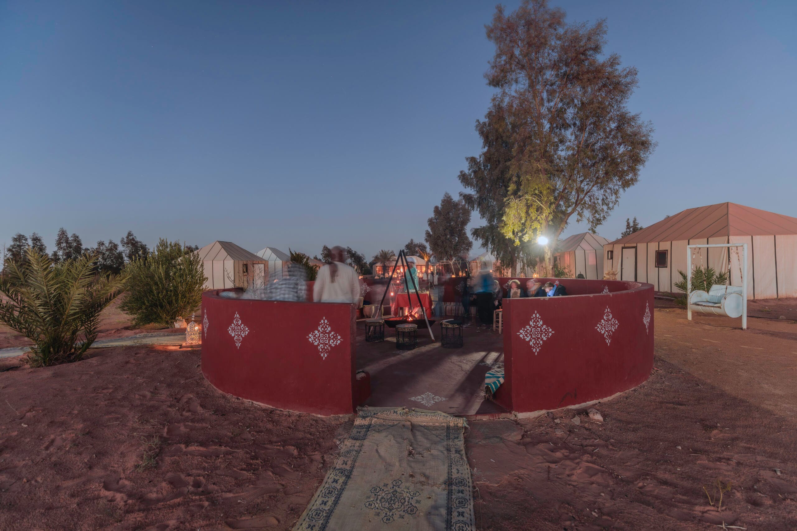 a group of people around a fire pit