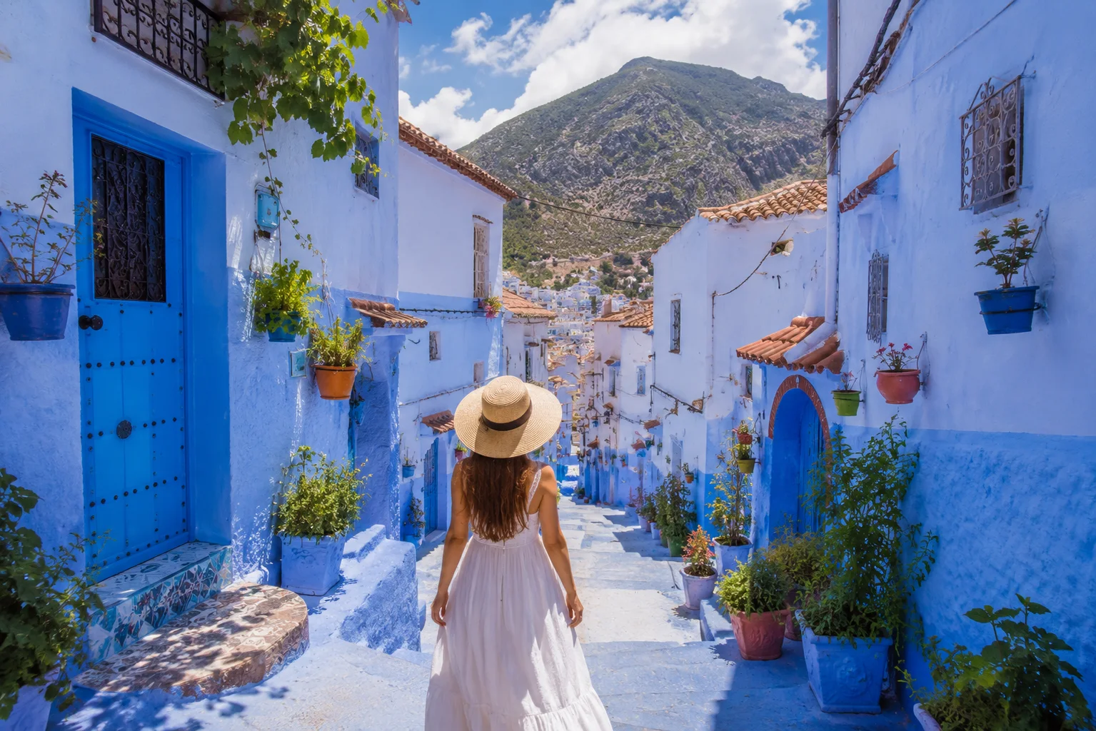 Traveler exploring the blue streets of Chefchaouen during a 4 Days Tangier to Marrakech Desert Tour